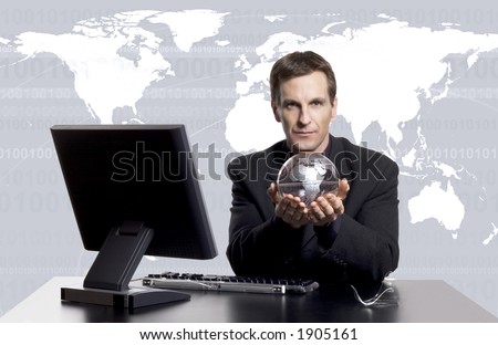 Businessman holding an earth globe with an earth map behind him.