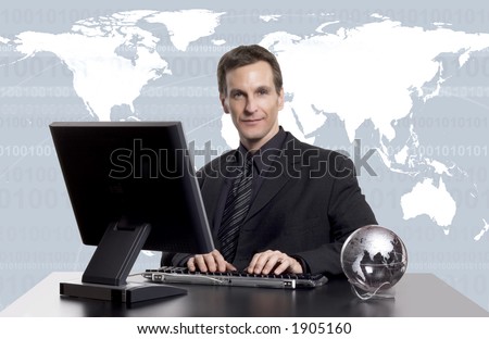 Businessman working on the computer, with an earth globe on his desk, and an earth map behind him.