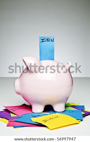 Piggy bank with IOU sticking out of its coin slot.