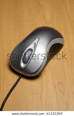 Metallic color computer mouse on wood surface