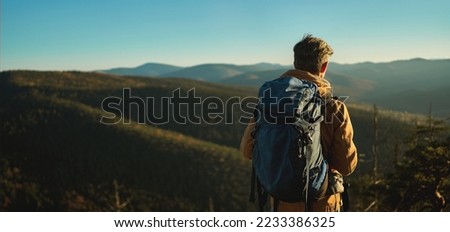 Similar – Image, Stock Photo backpacker man hiking in peak of mountain at sunset enjoying landscape. Lifestyle and nature