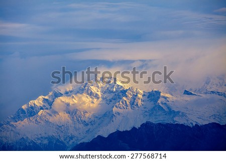 beautifull cloudy sunrise in the mountains with snow ridge. Annapurna region, Himalayas, Nepal.