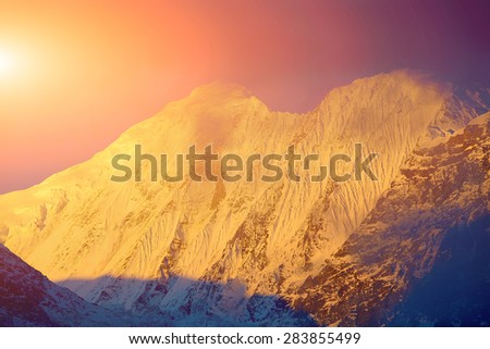 beautifull cloudy sunset in the mountains with snow ridge. Annapurna region, Himalayas, Nepal.