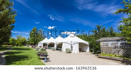 White tents set up for a large party or gathering