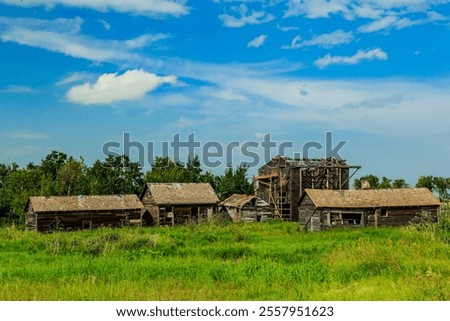 Similar – Image, Stock Photo A few wooden huts and many bushes and trees are standing around on a hilly green meadow landscape in the nature park Ammergau Alps in Upper Bavaria and a piece of bicycle path can be seen as well.