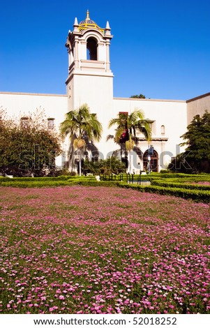 Pink flowers in spring in front of the architecture of Balboa Park