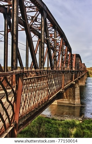 Old rustic steel bridge over the North Saskatchewan River near the town ...