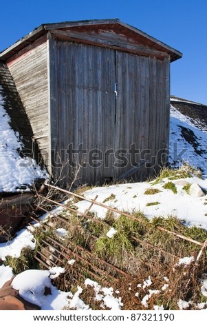 Old wooden barn on a sunny cold winter day