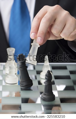 Corporate man in suit playing chess