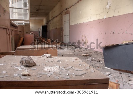 Pieces of broken glass among destroyed desks and lockers in an abandoned corridor  in an old school building Sofia, Bulgaria, May 12, 2014. Some of the doors and windows had been wrecked.