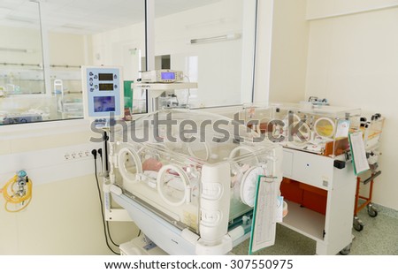 Newborn innocent babys are sleeping in incubators in the Obstetrics and Gynecology Hospital \