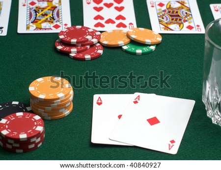 Poker game in progress - focus on players cards