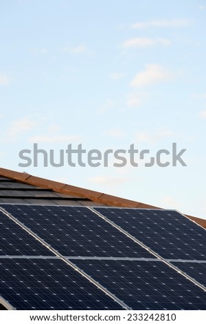 A shot of solar panels of a tiled roof