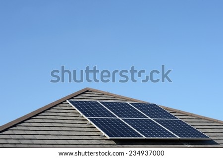 A shot of solar panels of a tiled roof