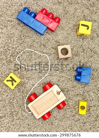 A close up shot of toys scattered over a wooden floor