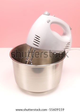 An electric hand mixer on a kitchen bench