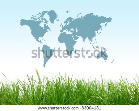 Green grass isolated against a blue sky with a world map
