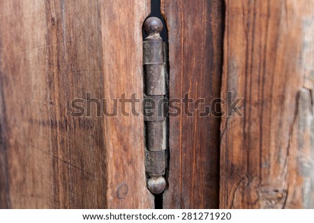 Closeup of old door hinge on wood door