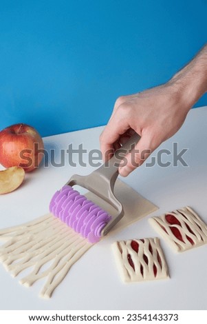 Similar – Image, Stock Photo Cook cutting dough with knife in shape on table