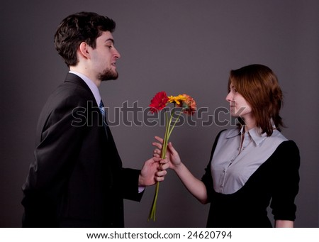 man  giving woman bouquet of flowers