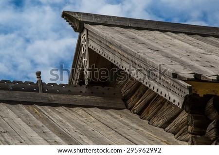 Traditional decoration of wooden houses, windows and balconies. Wooden house in the Russian north.