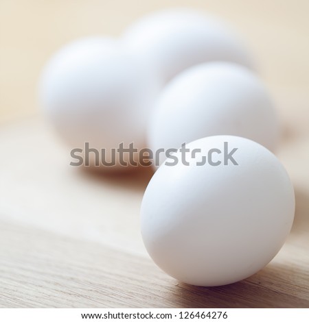 White eggs on the wooden table