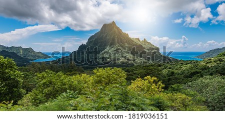 Panoramic mountain peak landscape with Cook's Bay and Opunohu Bay on the tropical Island of Moorea, French Polynesia.