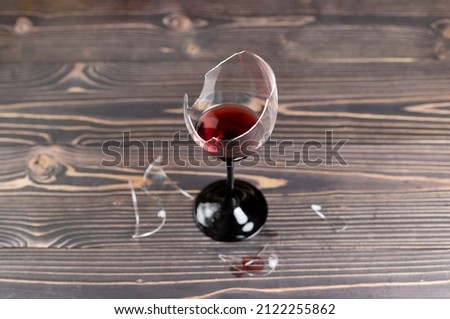 A broken wine glass on the wooden floor. selective focus Photo stock © 