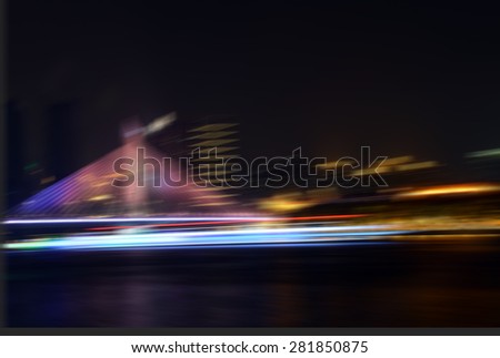 Boat traveling under the bridge at night