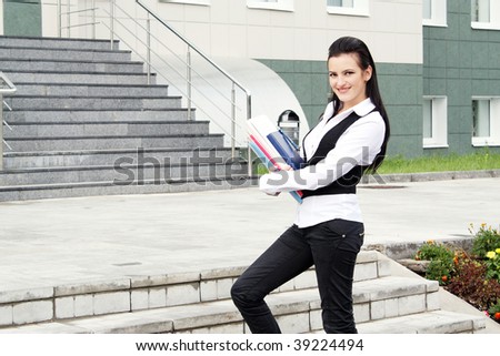 Portrait of the young business woman in the beginning of a career ladder