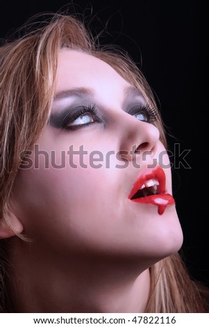 Girl - a vampire with blood dripping on his lips