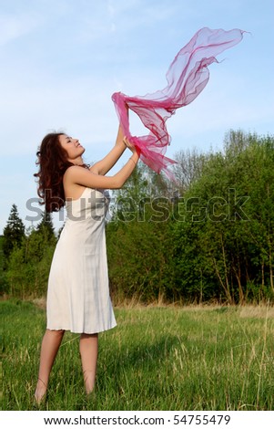 Girl dances with a scarf on nature