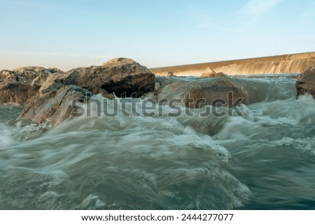 Similar – Image, Stock Photo Further wet beach in the shimmer of the sunset. Waves, clouds and people in the distance.