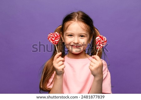 Image, Stock Photo Girl with lollipops in the form of a kiss