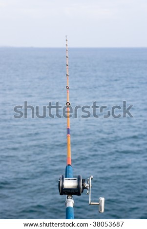 a fishing pole leading out into the ocean