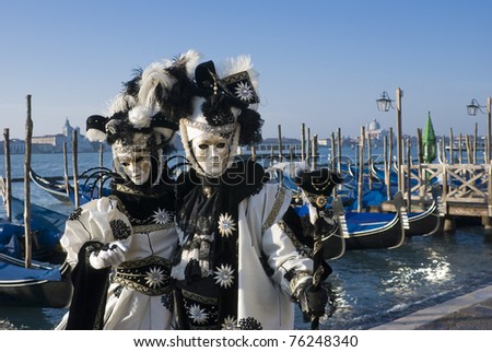 VENICE, ITALY - MARCH 4: Two costumed street performers pose during the Carnival celebration on San Marco Square on March 4, 2011 in Venice, Italy.