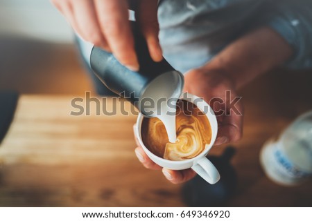 Similar – Image, Stock Photo Barista preparing a coffee at the sieve carrier machine in a café