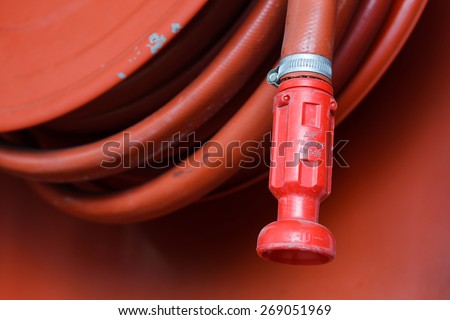 Red fire hose in the reel