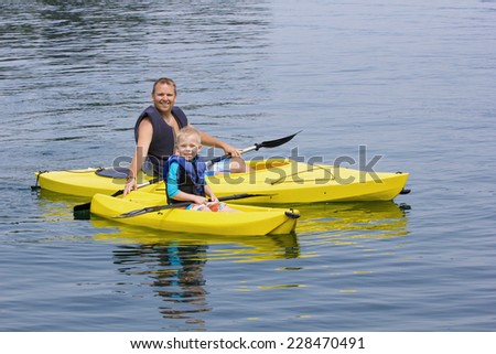 Family Kayaking together on a beautiful lake