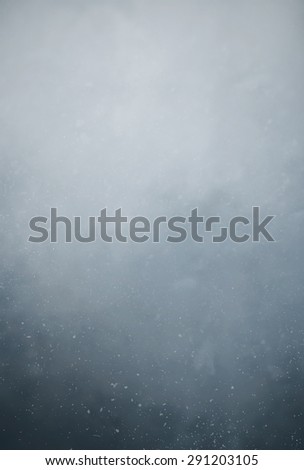 Dust particles floating in the air against dark background