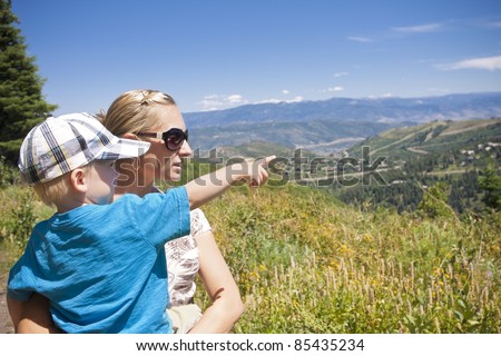 Child pointing while on a family hike in the mountains