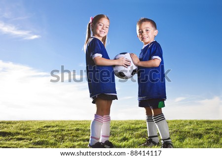 Youth Soccer players smiling together on a grass field
