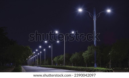 Similar – Foto Bild bunte Straßenlaternen bei Nacht auf der Straße