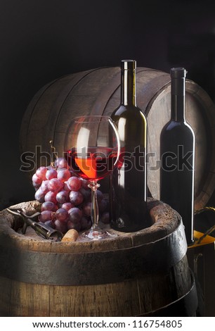 still life with red wine and old wood barrel  and cluster