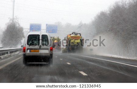 TILBURG, NETHERLANDS -Â?Â? DECEMBER 7 : Code orange because of heavy snowfall makes driving on the highway\'s very difficult on dec. 7, 2012 Tilburg, Netherlands.Snow ploughs  are cleaning the road .