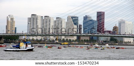 ROTTERDAM - SEPTEMBER 7, 2013: The World Port Days at the port of Rotterdam  on September 7 , 2013 in Rotterdam, There are rowing boats under the Erasmusbridge during a race on the maas river.