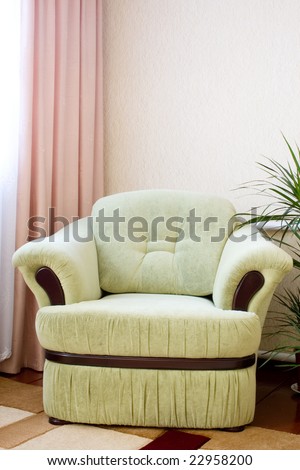 armchair in the corner of room near a window
