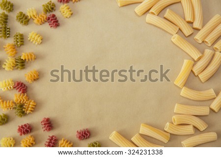 Raw uncooked pasta noodles arranged in a frame with free space to fill in