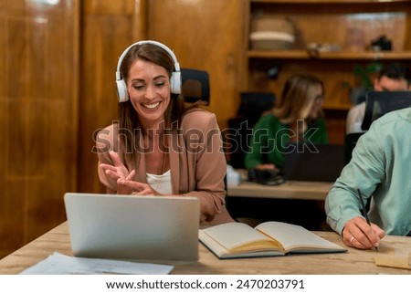 Image, Stock Photo Young Man smiling while talking to someone on his laptop.