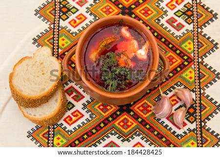 Ukrainian soup and bread with garlic on embroidered towel